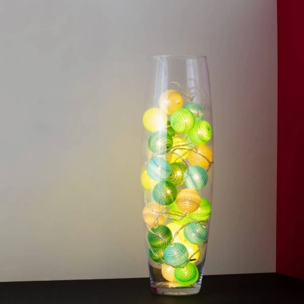Forest green themed LED cherry light in a clear glass vase.